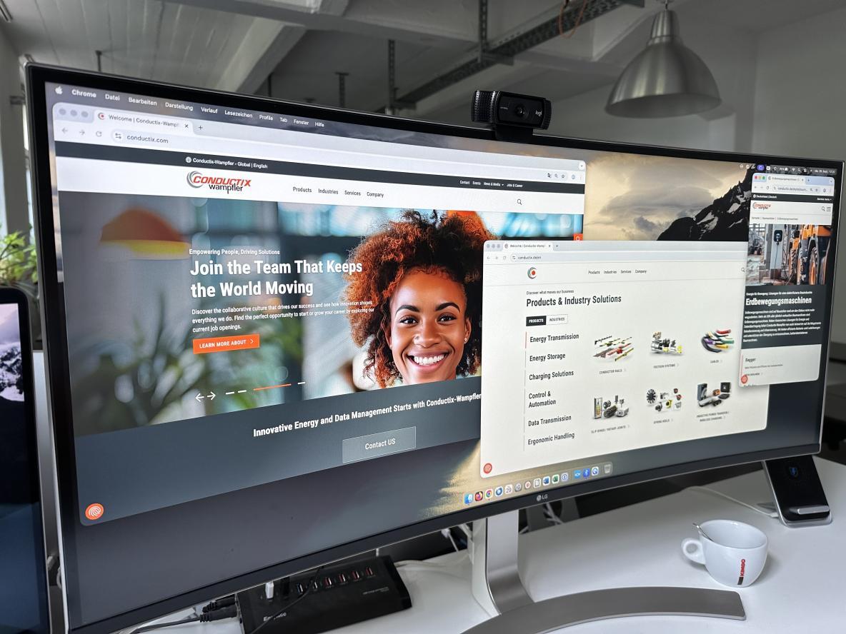 Widescreen-Monitor, der verschiedene Ansichten der Conductix Wampfler Webseiten zeigt